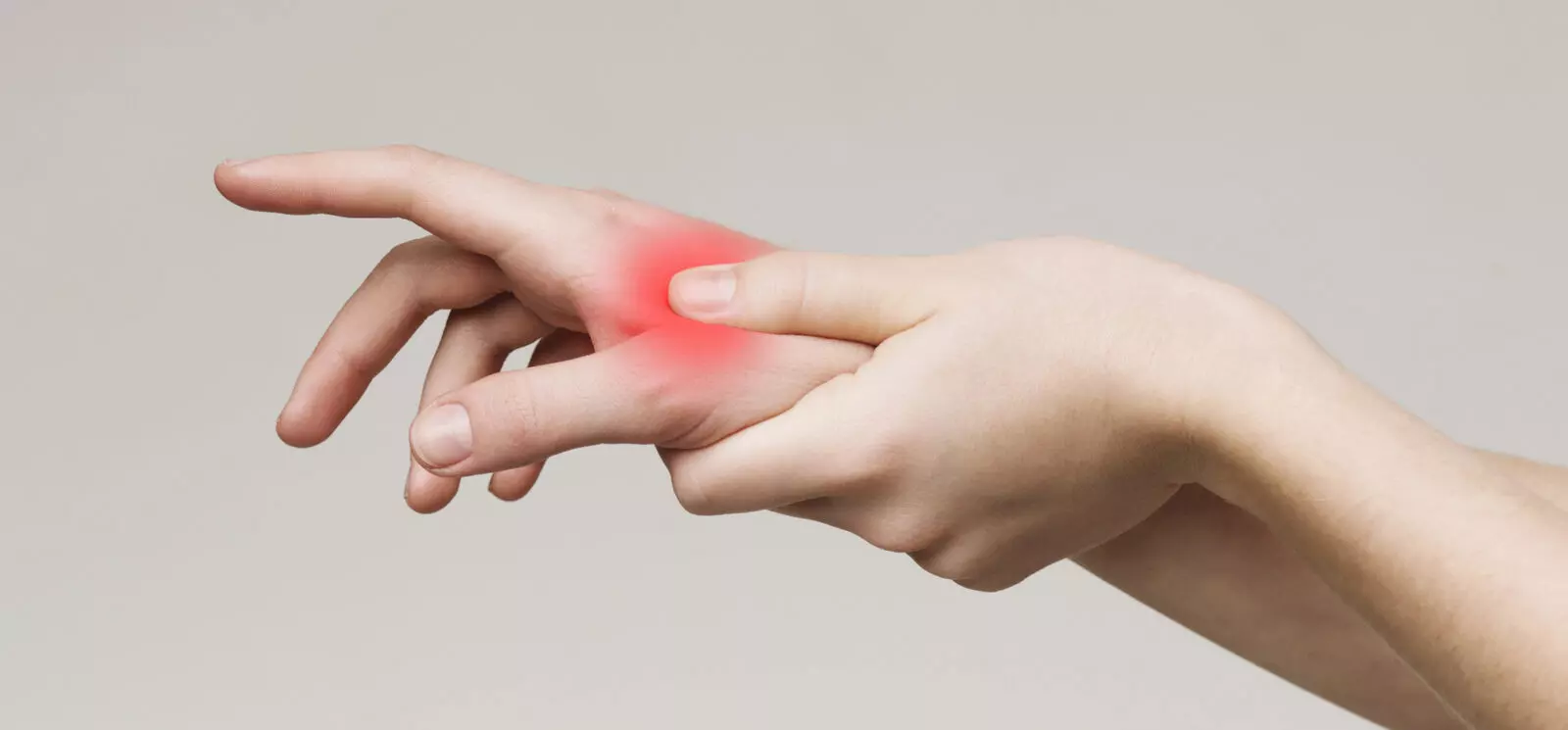 Young woman massaging her arthritic hand and wrist, panorama, close up